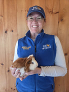 Farmer Joe's Gardens team member holding a guinea pig